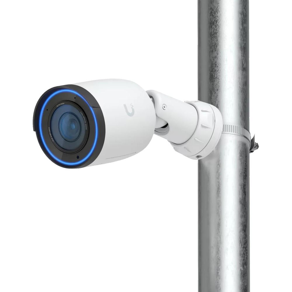 White security camera with blue light ring, mounted on a metal pole.