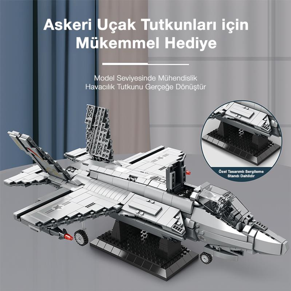 Gri model uçak bir stant üzerinde, üzerinde yazı var.