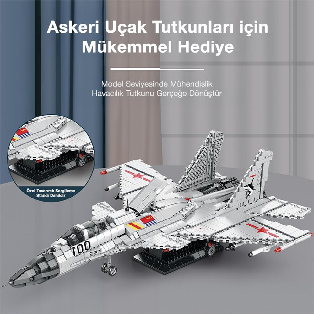 Gümüş renkli model uçak, üzerinde kırmızı işaretler, sergileme standında.