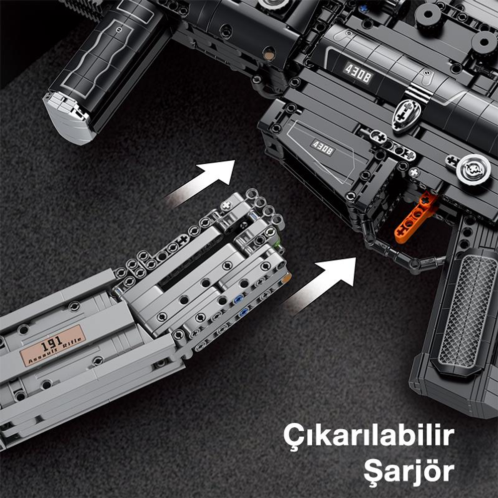 Gri Lego şarjör, siyah Lego silahtan çekiliyor.