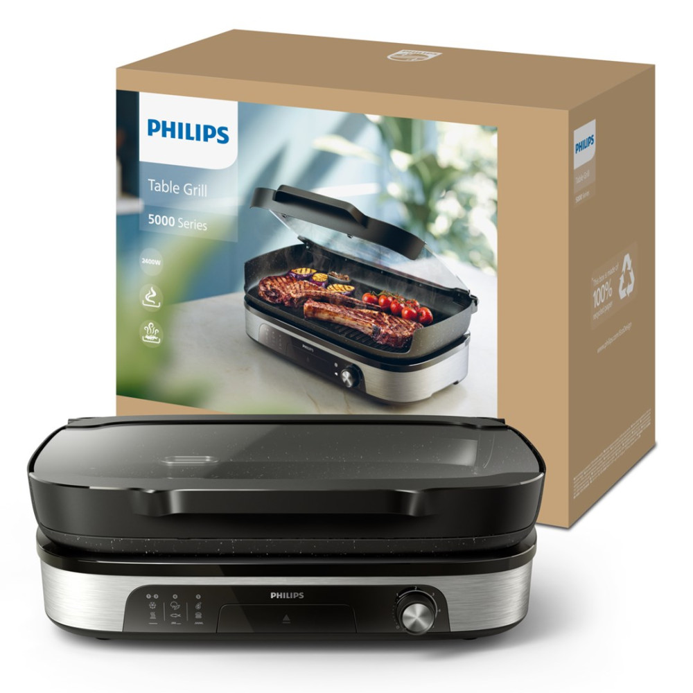 Grill stołowy Philips ze stekami i warzywami, obok pudełka.
