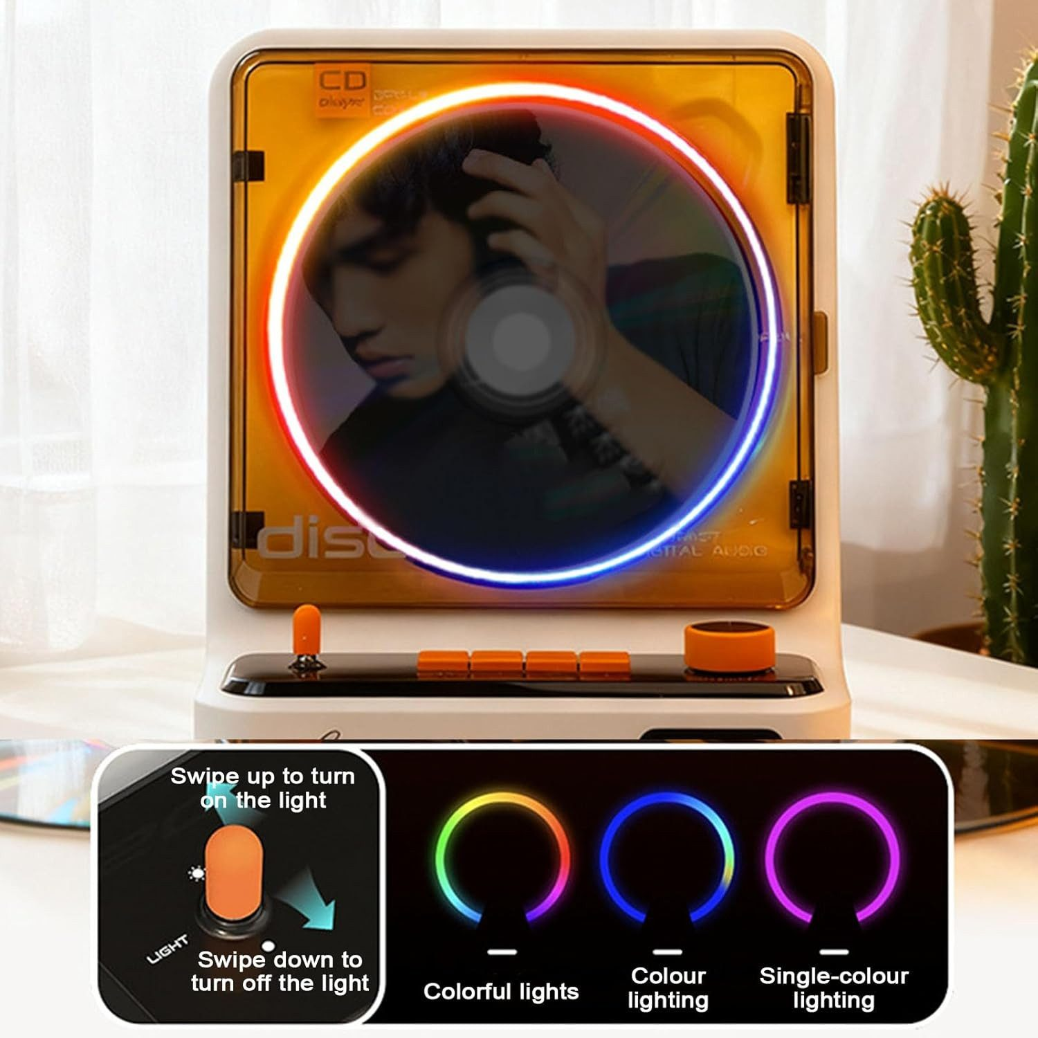 CD-Player mit buntem Lichtring, Regler und Kaktus. Bedienungsanleitung abgebildet.