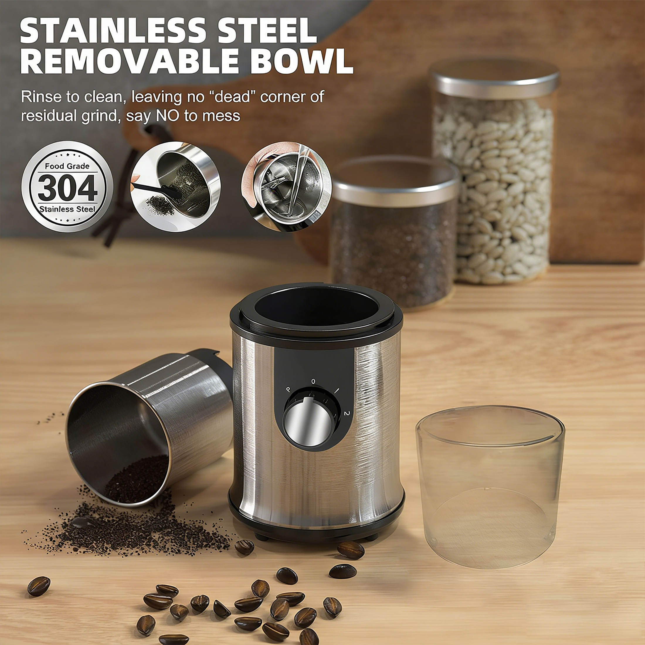 Edelstahl-Kaffeemühle mit abnehmbarem Behälter, Kaffeebohnen und gemahlenem Kaffee.