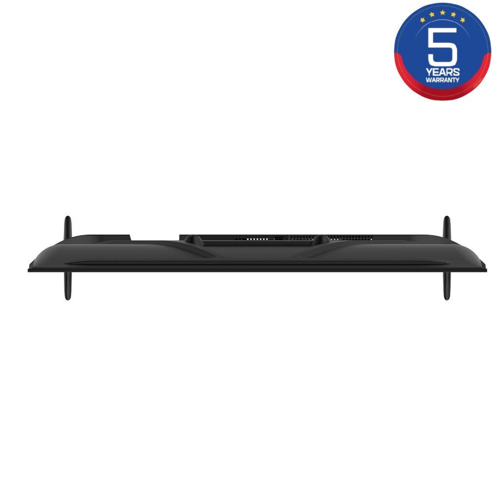 Vista superior de un televisor negro con insignia de garantía de 5 años azul y roja.