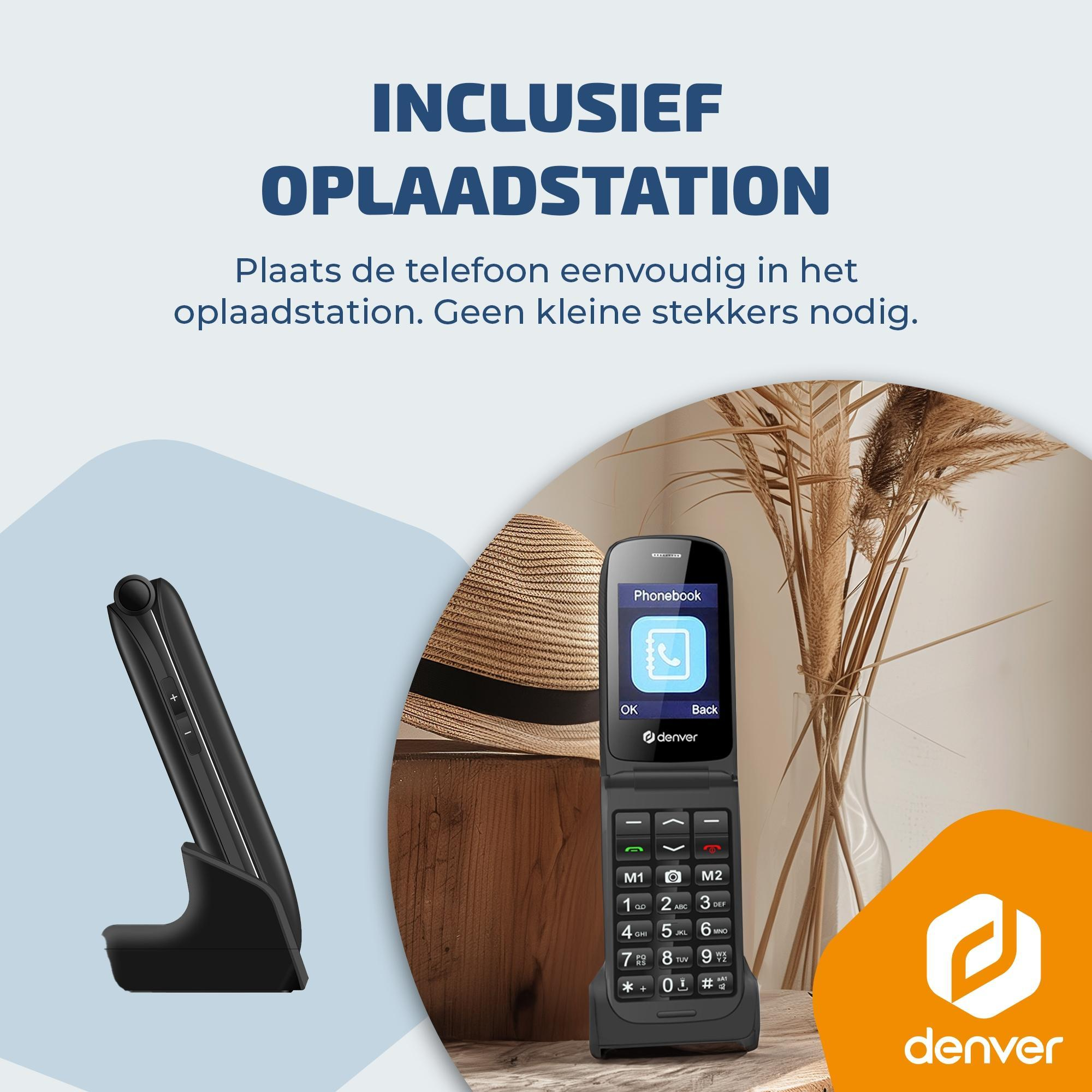 Un téléphone à clapet noir avec station de charge, chapeau et fleurs séchées.