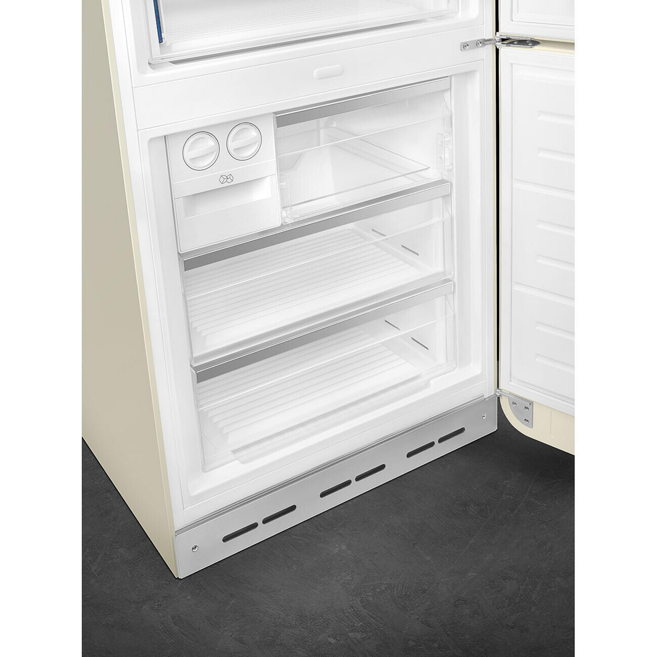 Un refrigerador abierto color crema con cajones y estantes transparentes.