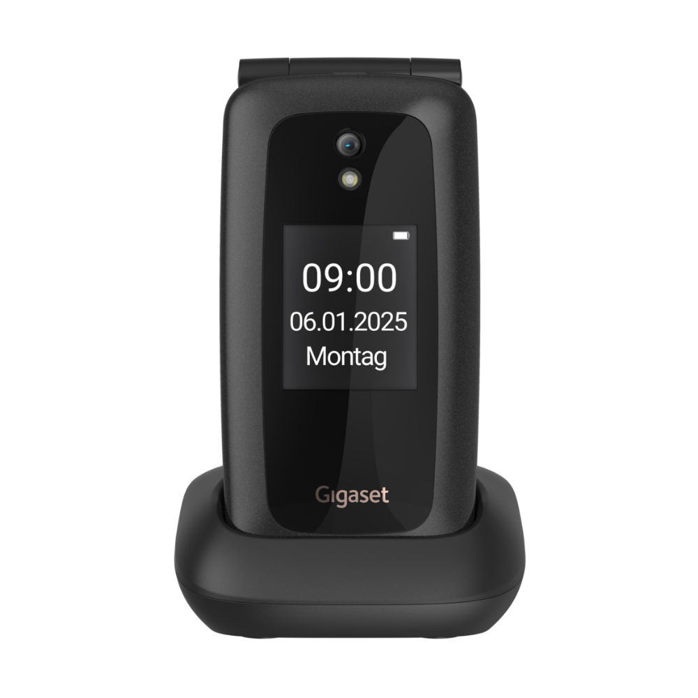 Un téléphone à clapet noir Gigaset est dans sa station de charge. L'écran affiche 09:00, 06.01.2025, Montag.