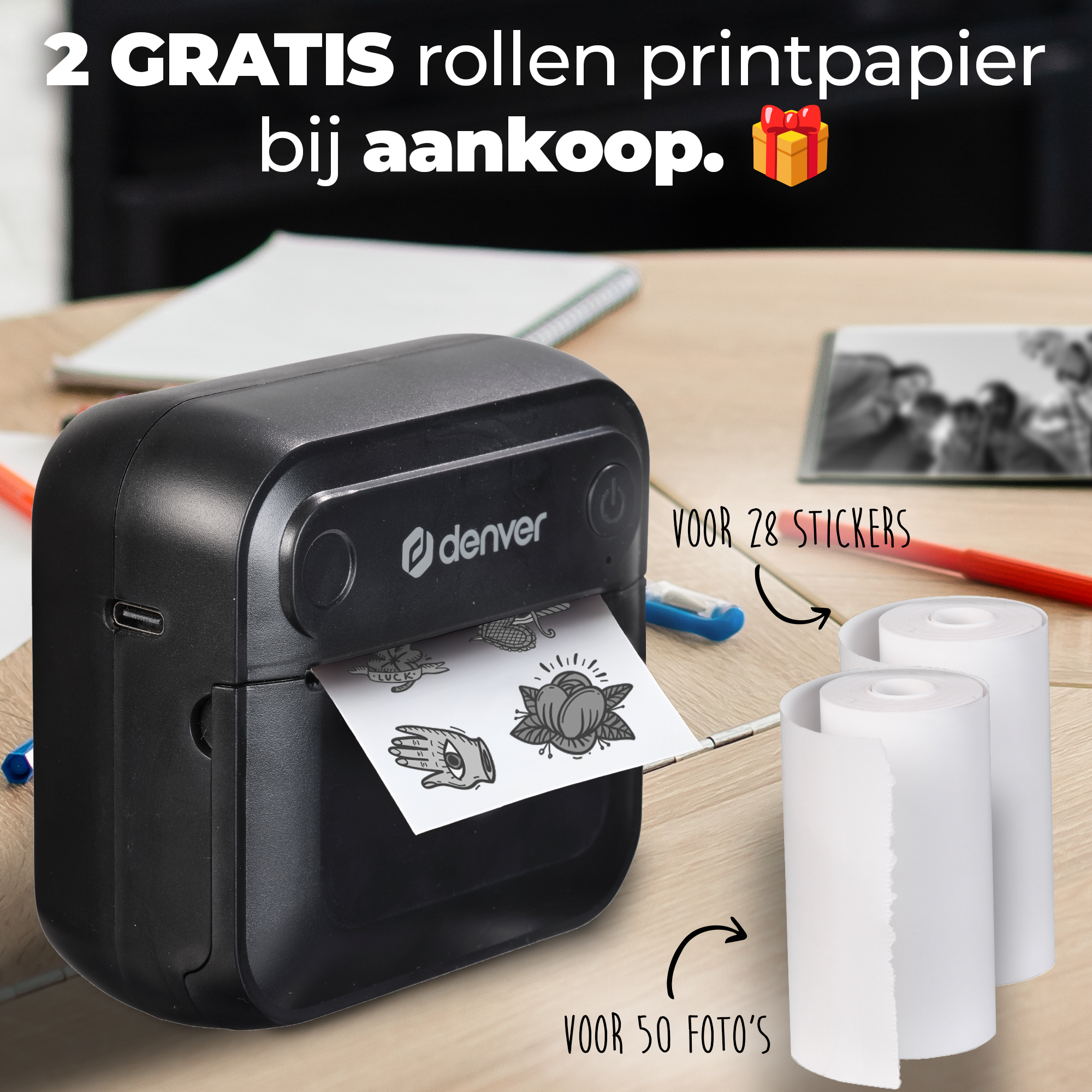A Denver printer prints stickers, with two rolls of paper beside it.