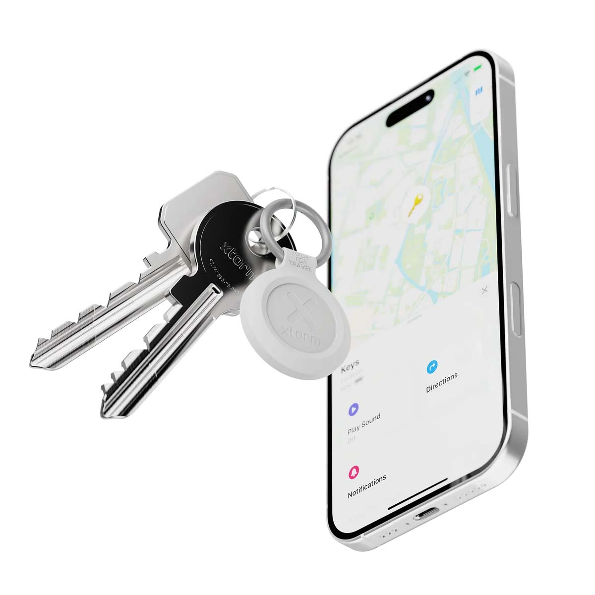 Un localizzatore bianco Xtorm su chiavi accanto a un telefono che mostra una mappa.