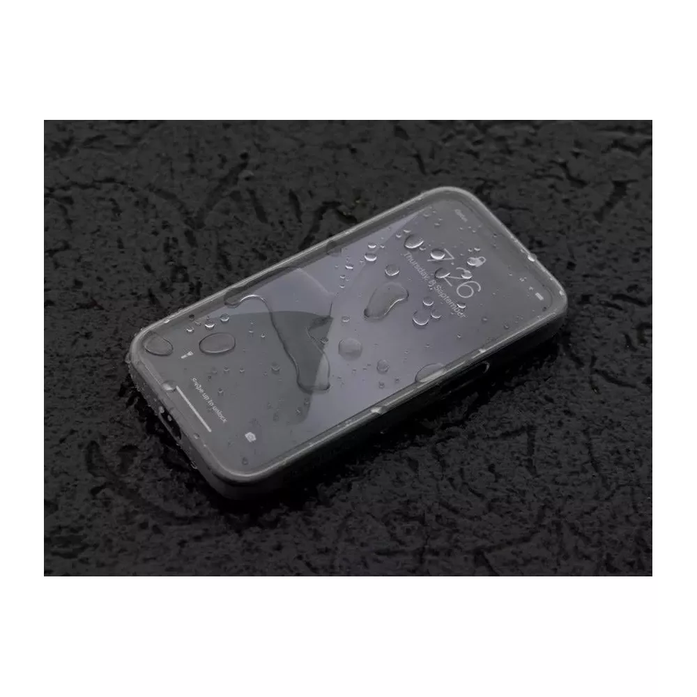 Ein Smartphone mit Wassertropfen auf dem Bildschirm liegt auf einer dunklen, nassen Oberfläche.