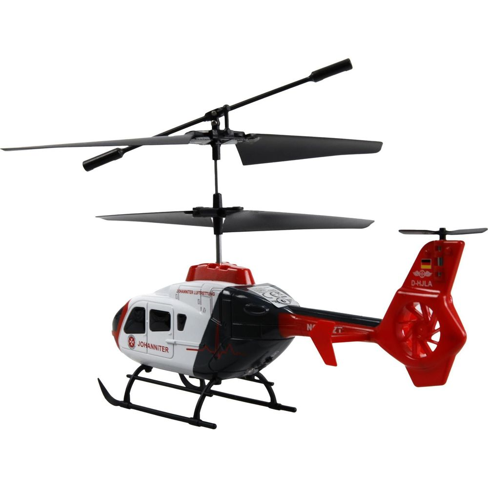 Ein Spielzeughubschrauber in Weiß, Schwarz und Rot mit Doppelrotor und Landegestell.
