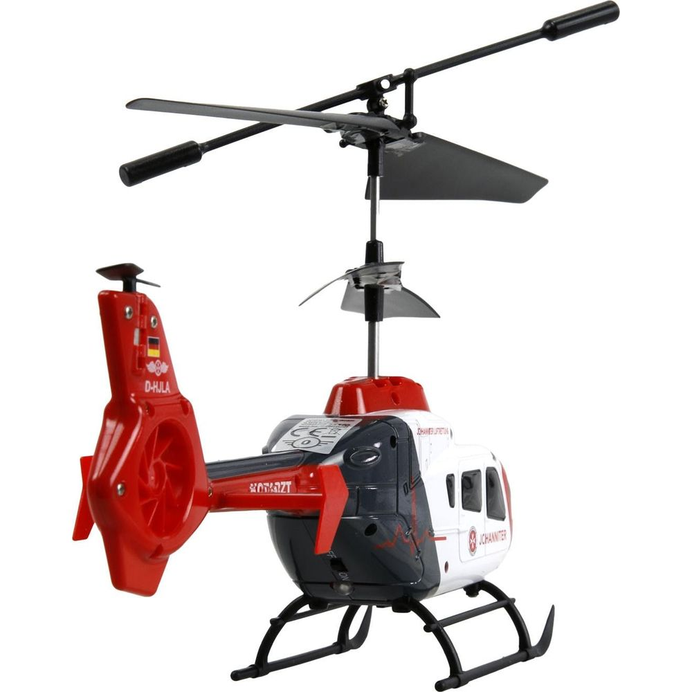 Ein roter und weißer Spielzeughubschrauber mit schwarzen Rotorblättern und Landegestell.