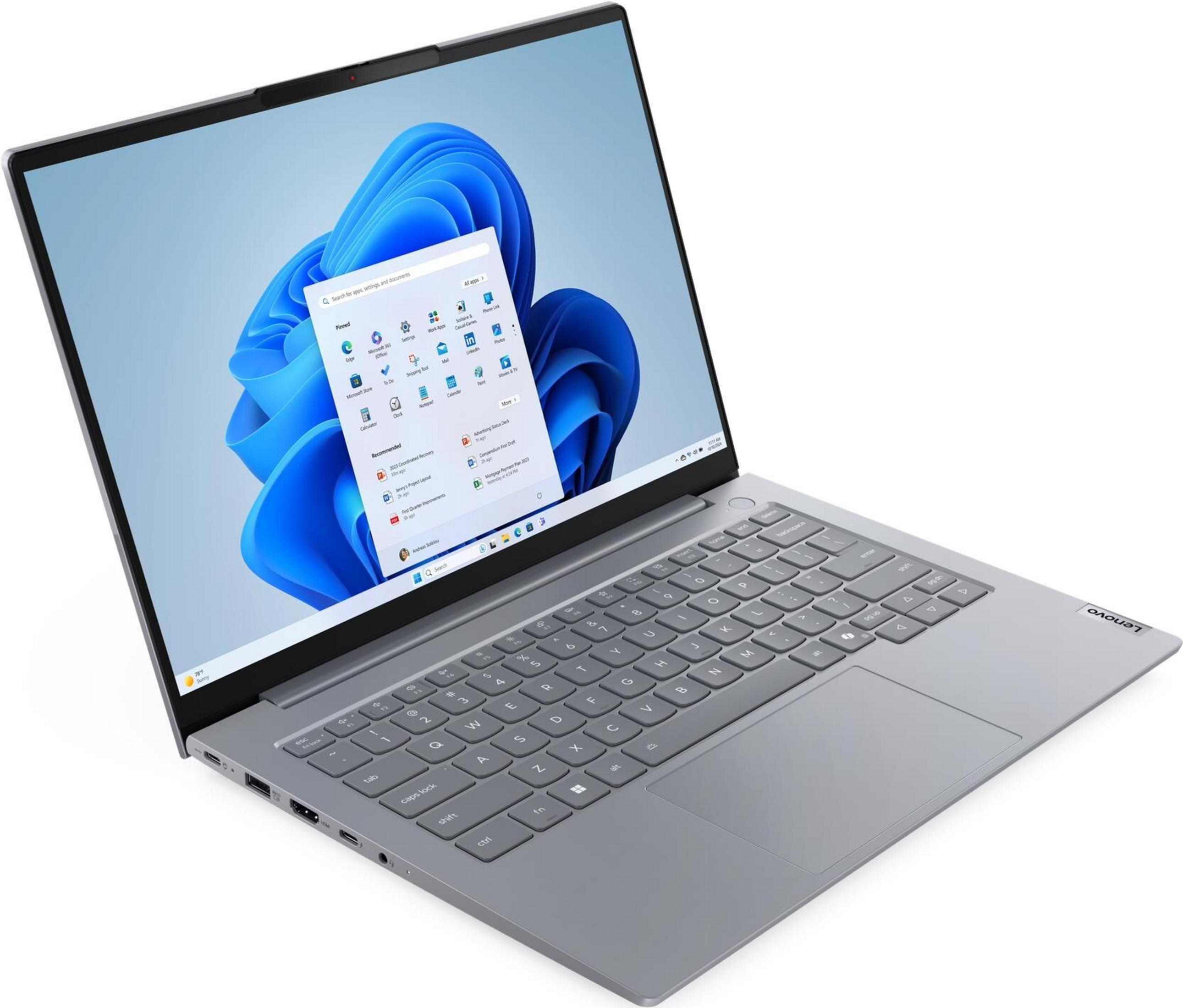 Grauer Lenovo Laptop mit geöffnetem Bildschirm, der das Windows 11 Startmenü zeigt.