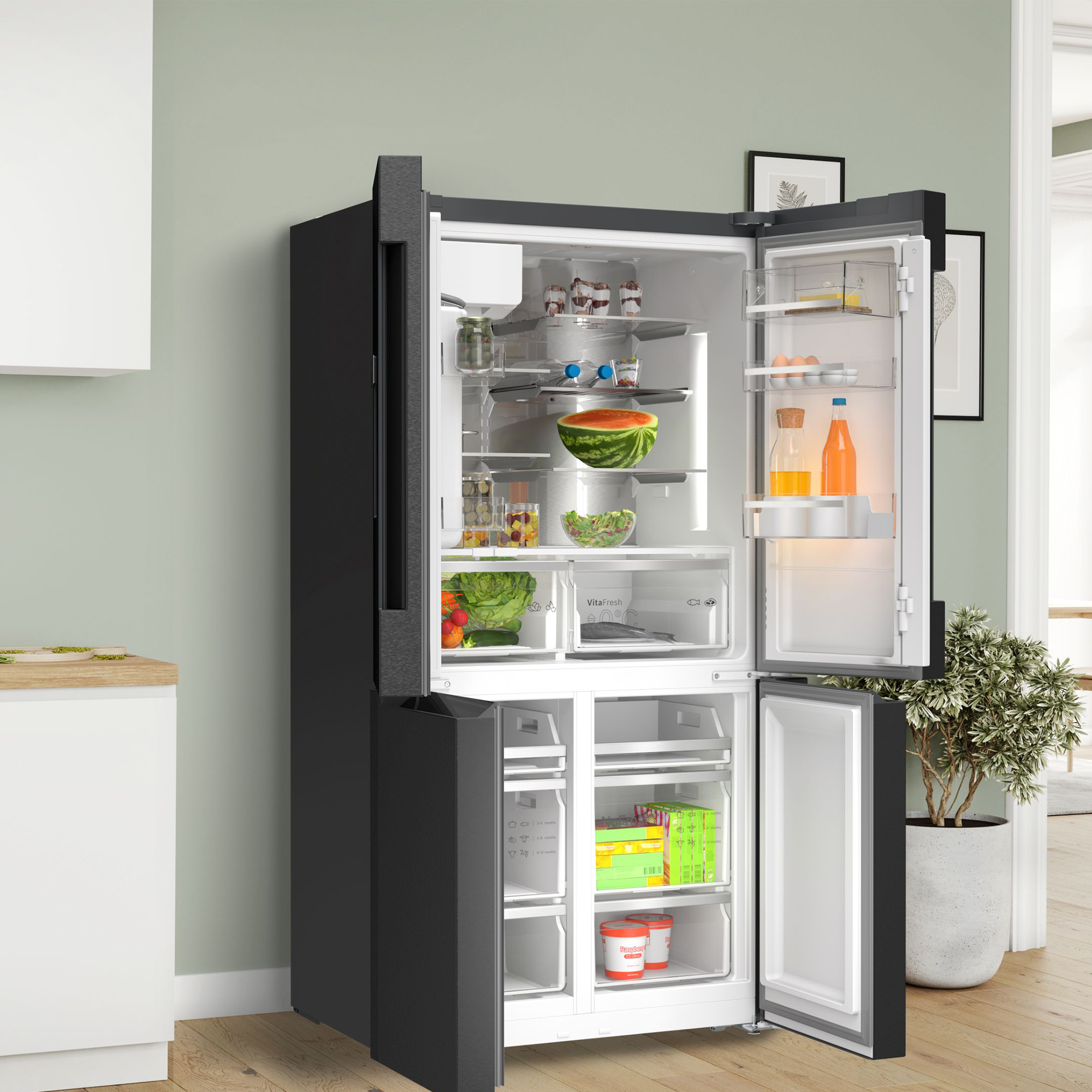 Ein offener schwarzer Kühlschrank mit Lebensmitteln wie Wassermelone, Salat und Eiern.