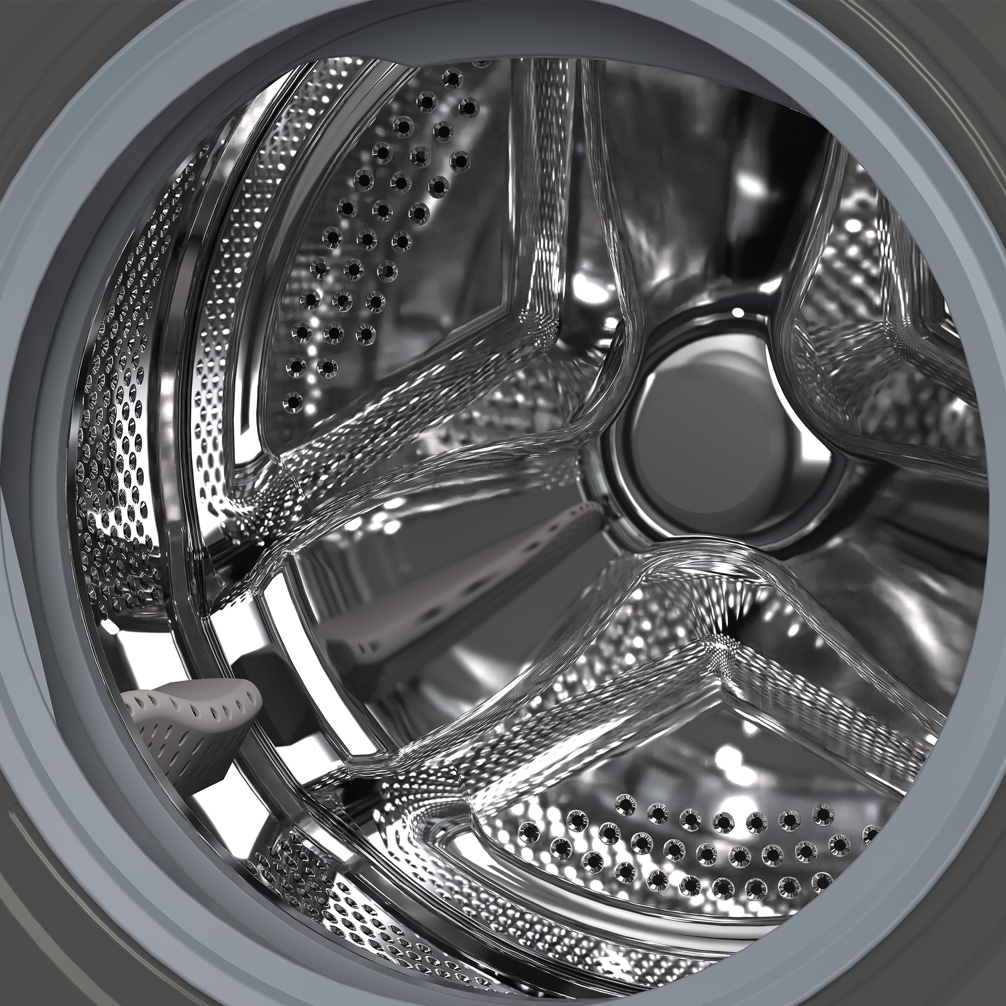 Vue intérieure du tambour d'une machine à laver, surface métallique brillante et perforée.