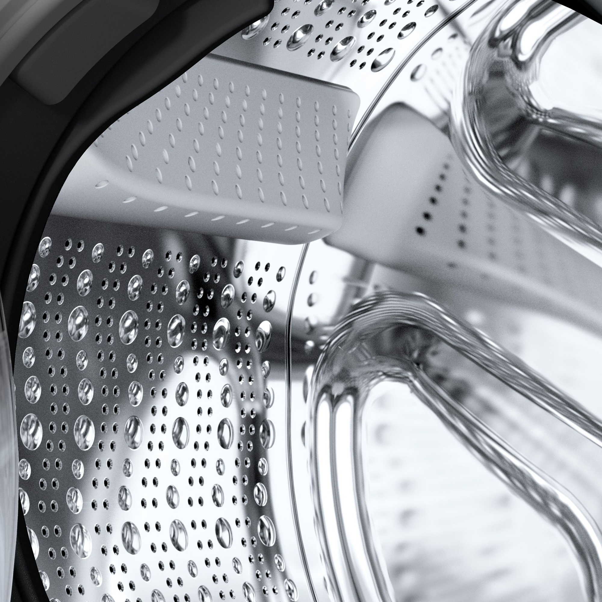 Detailaufnahme der Trommel einer Waschmaschine mit Wassertropfen auf perforierter Oberfläche.