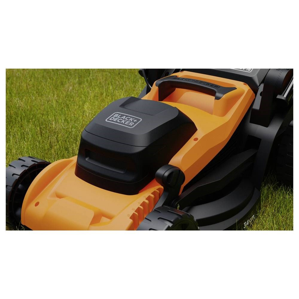 Pomarańczowo-czarna kosiarka z logo Black+Decker stoi na zielonej trawie.