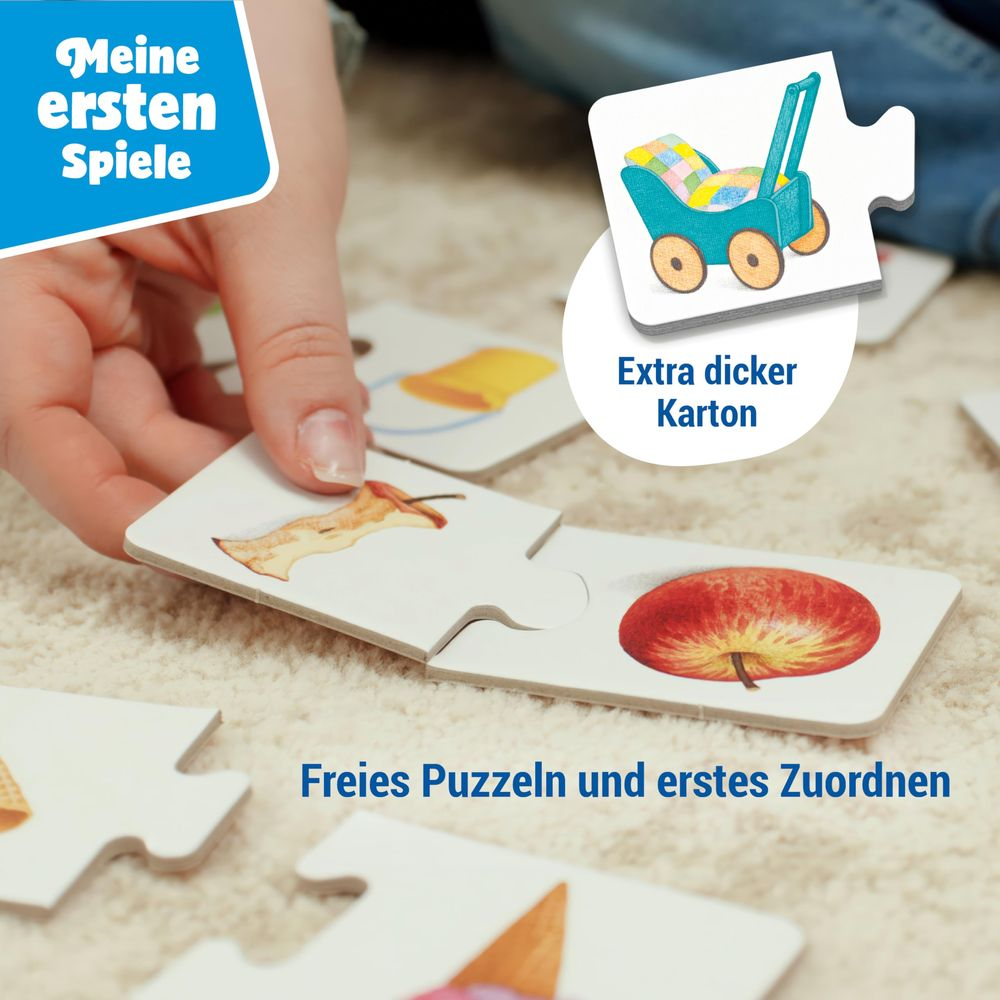 Giocattolo per bambini: Pezzi di puzzle con motivo di mela, su un tappeto.
