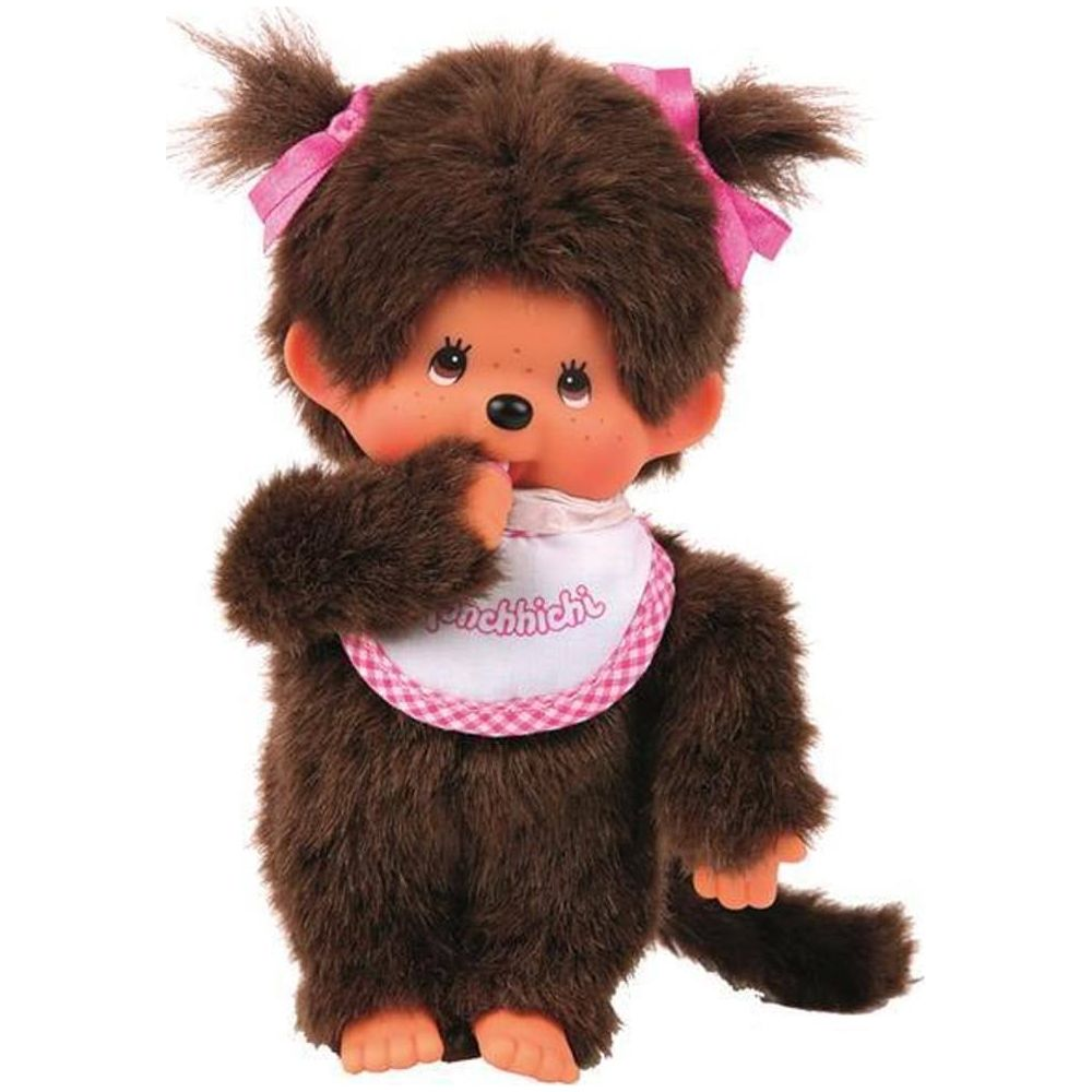 Ein brauner Monchhichi mit rosa Schleifen im Haar und einem weißen Lätzchen.