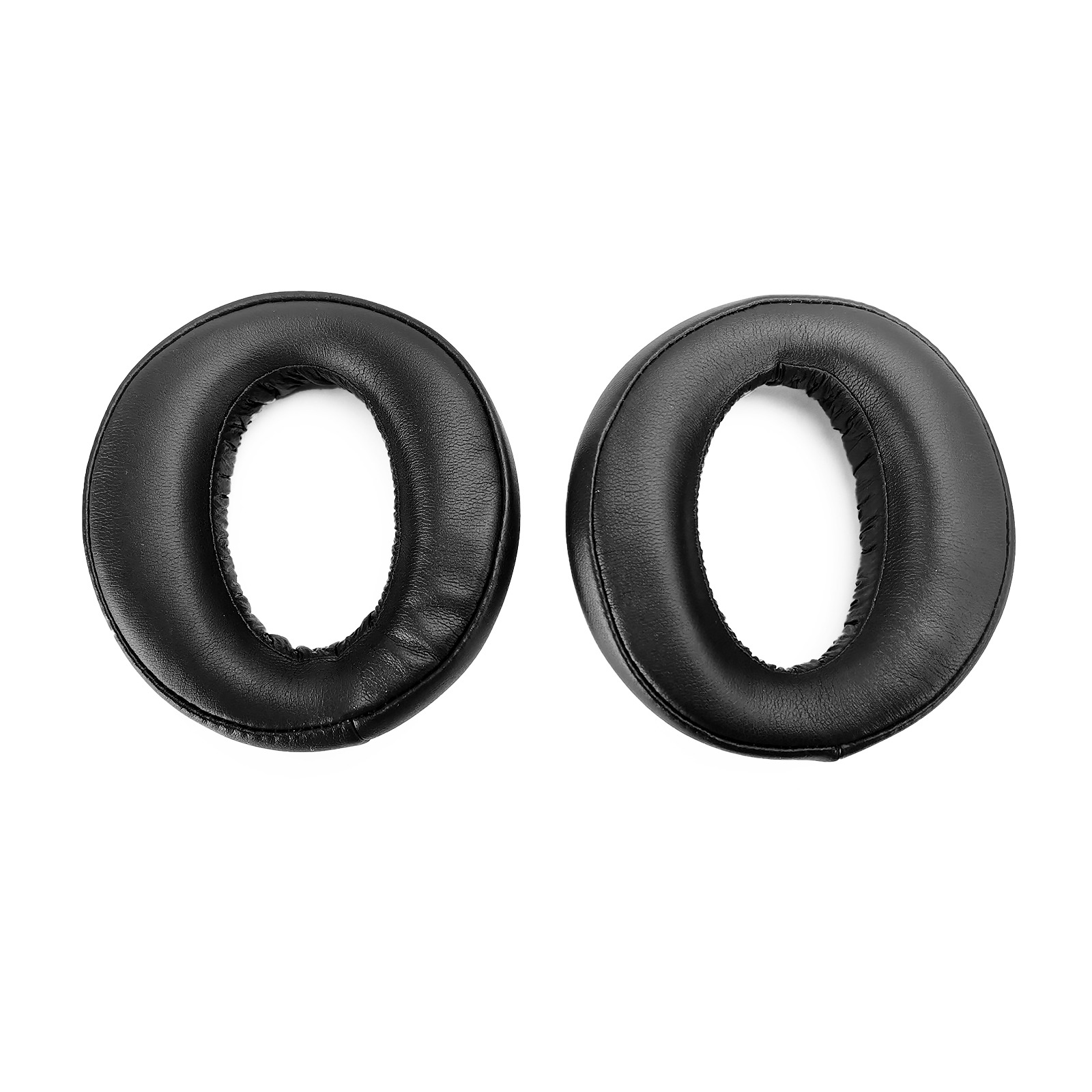 Deux coussinets d'oreille ronds en cuir noir pour casque sur fond blanc.