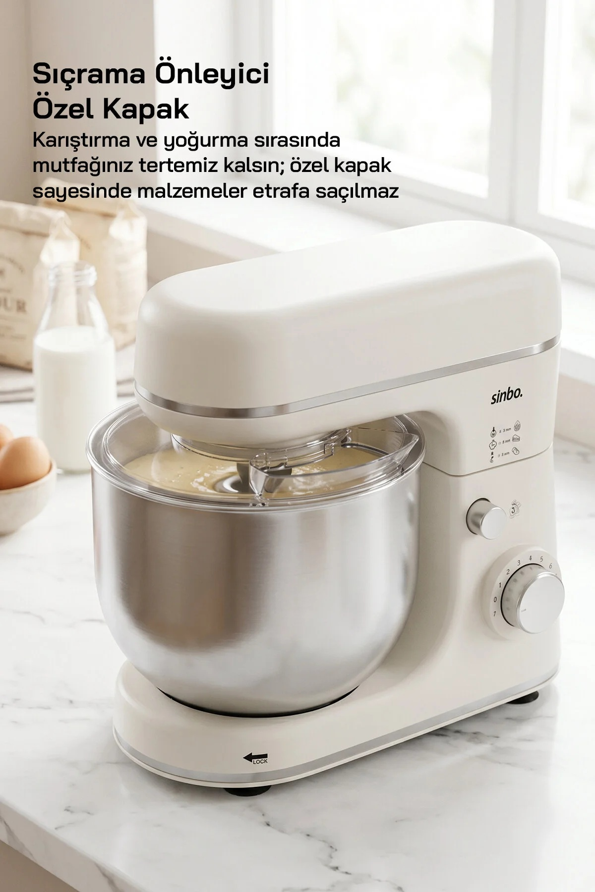 Paslanmaz çelik haznesi olan beyaz mutfak robotu hamur karıştırıyor. Tezgahta malzemeler var.