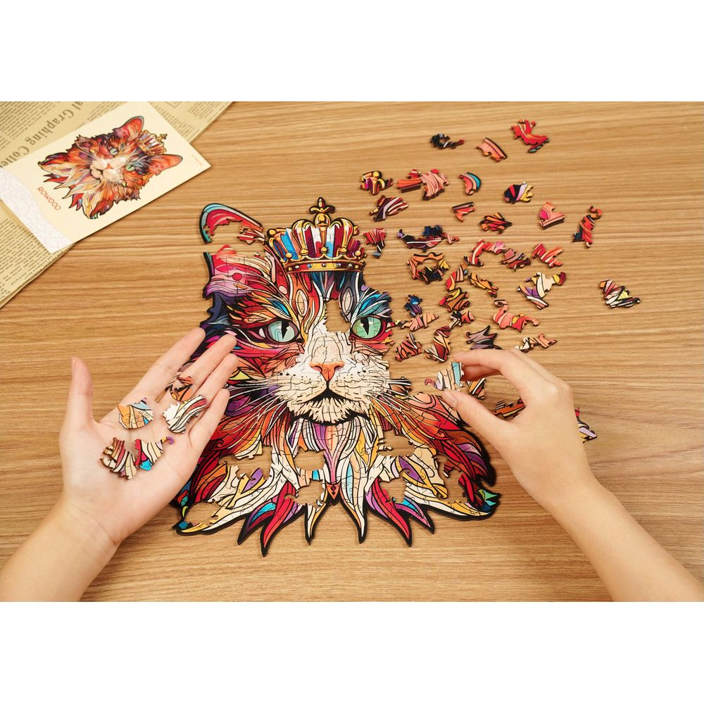 Bunte Katze als Holzpuzzle, das auf einem Holztisch zusammengesetzt wird.