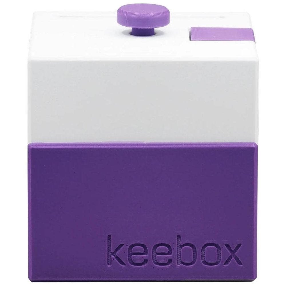 Un cubo Keebox bianco e viola con un pulsante e un interruttore.