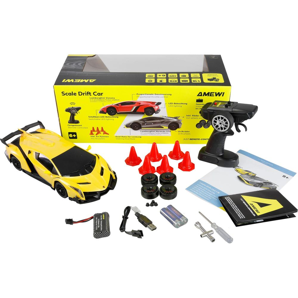 Ein gelbes RC-Driftcar mit Zubehör: Fernsteuerung, Batterien, Pylonen, Räder, Werkzeug.