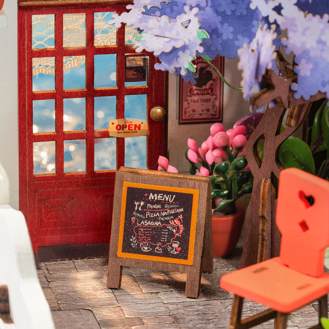 Scène de café miniature avec porte rouge, enseigne "Open" et menu.
