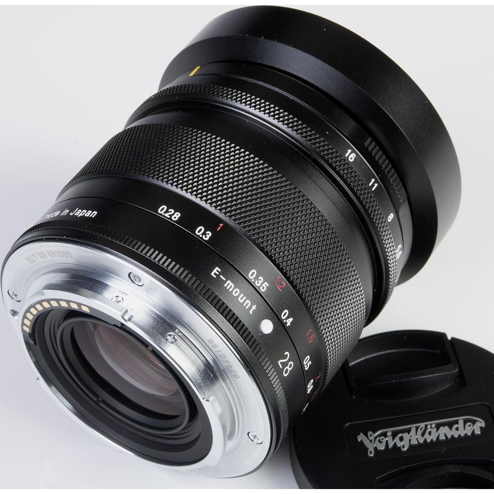 Black Voigtlander E-mount camera lens with focus and aperture rings, made in Japan.