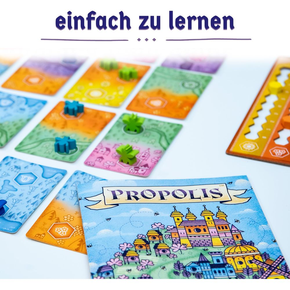 Brettspiel mit bunten Karten, Holzfiguren und dem Titel "Propolis".