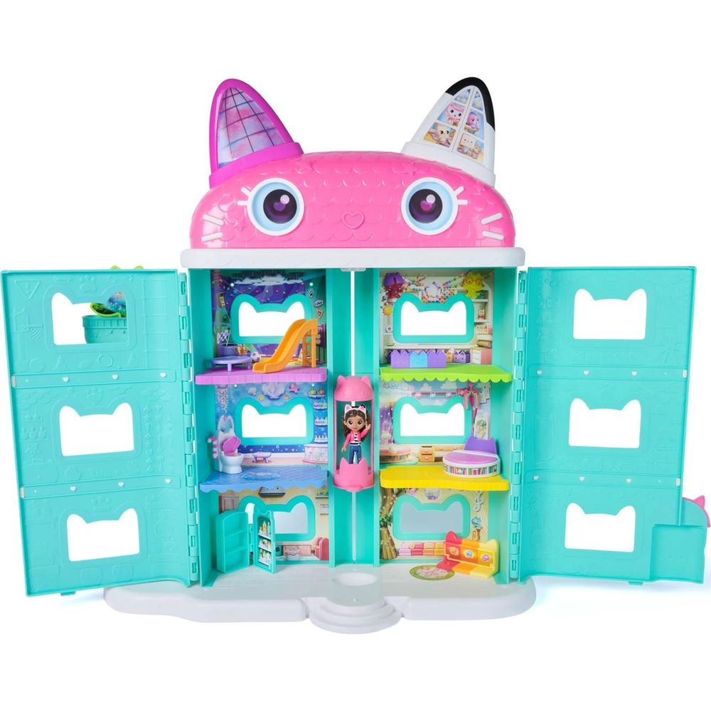 Ein pinkes puppenhaus in katzenform mit offenen türen, zeigt zimmer und möbel.