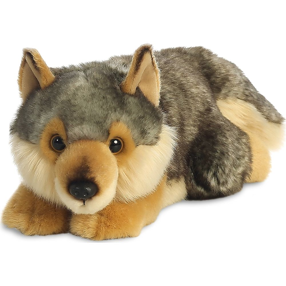 Ein Plüschwolf liegt auf dem Bauch, mit grauem und braunem Fell und aufmerksamen Augen.
