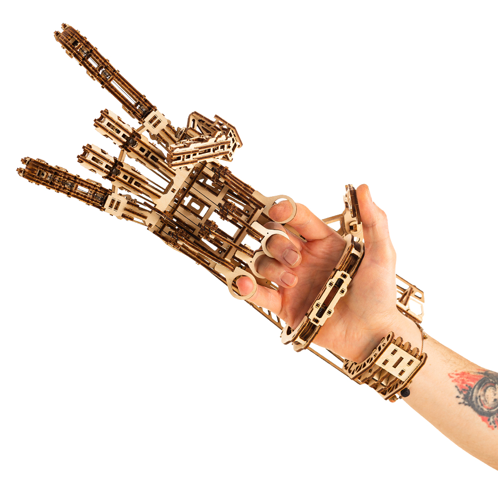 Modèle bois main robotique sur bras humain, faisant un geste rock'n'roll.