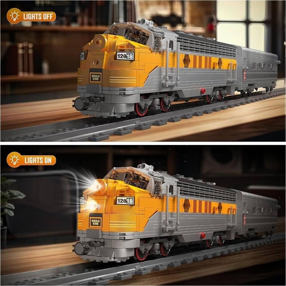 Un modèle de train Lego jaune et gris, lumières allumées et éteintes, sur rails.