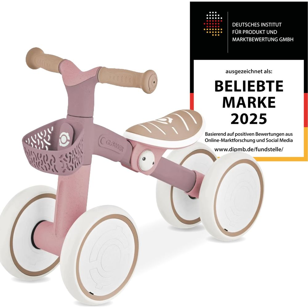 Una bici senza pedali rosa con dettagli beige, premiata come marchio popolare 2025.