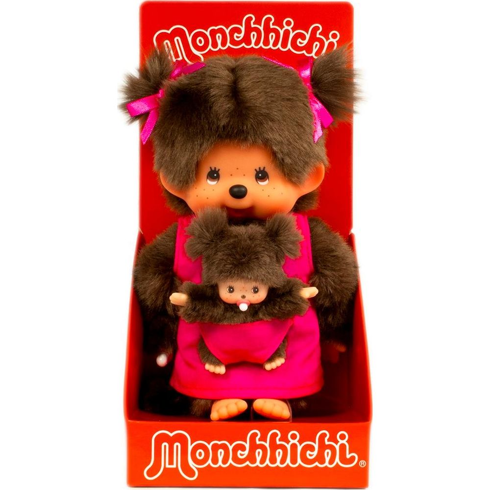 Ein Monchhichi-Mädchen mit Baby in pinker Trage, im Karton.