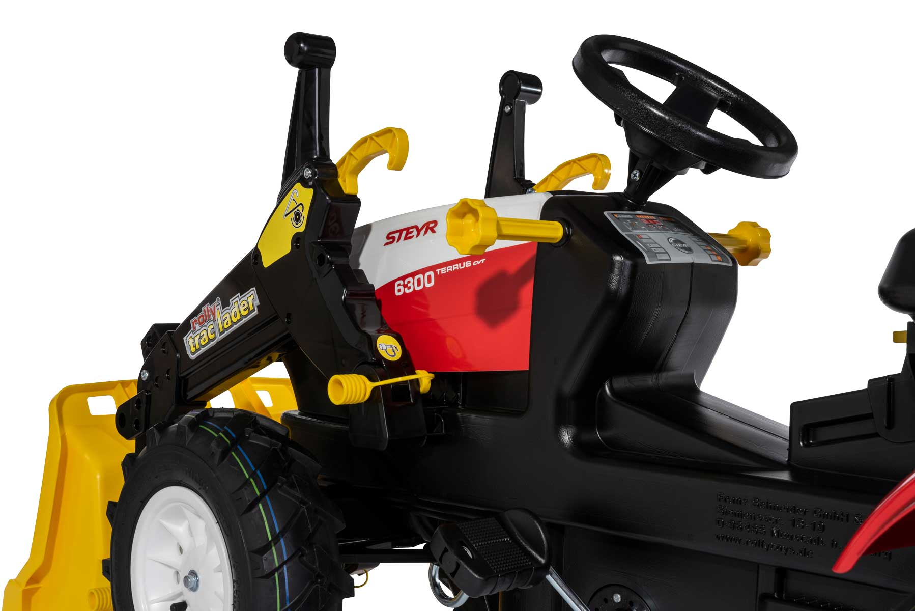 Ein Kindertraktor mit gelber Ladeschaufel, schwarzem Lenkrad und roten Akzenten.