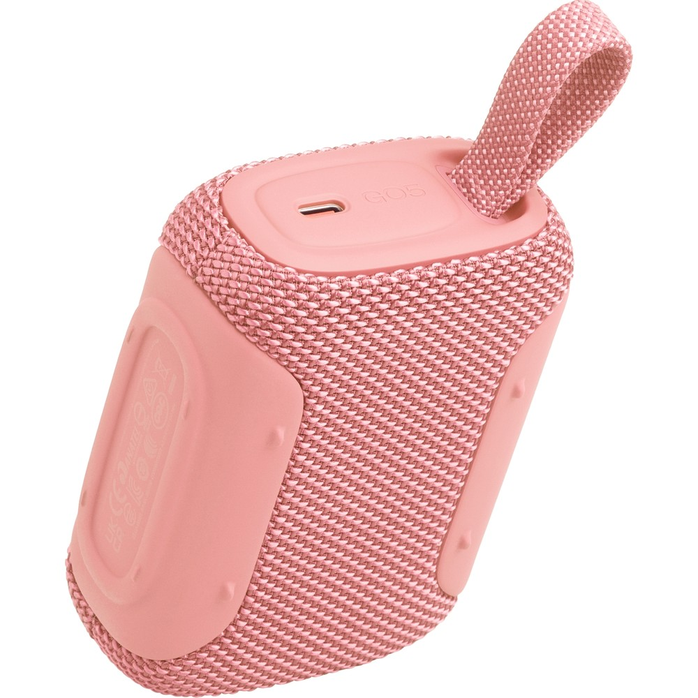 Un piccolo speaker Bluetooth rosa in tessuto con un anello.