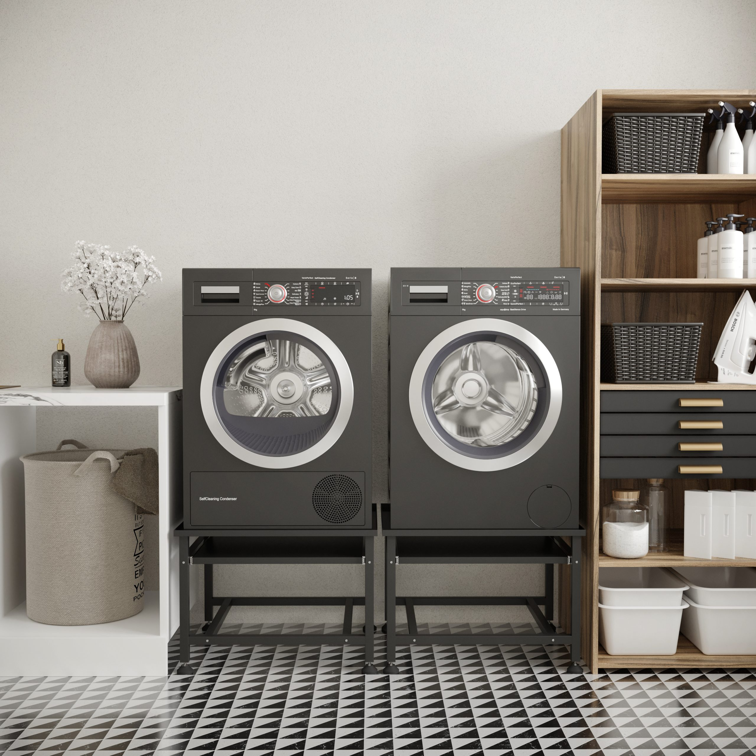 Two black washing machines stand side by side on metal stands.