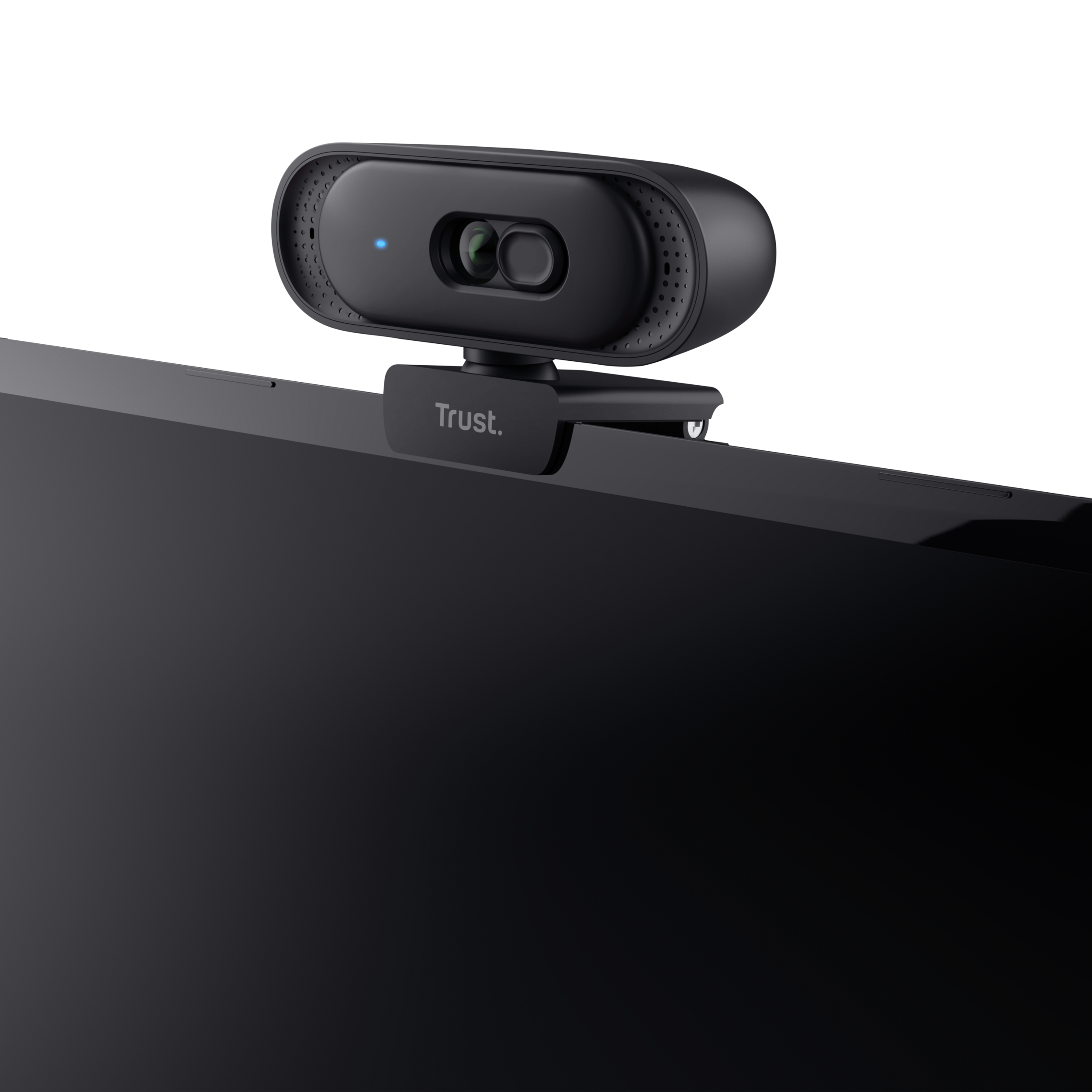 Eine schwarze Webcam mit dem Trust-Logo, die auf einem Laptop montiert ist.