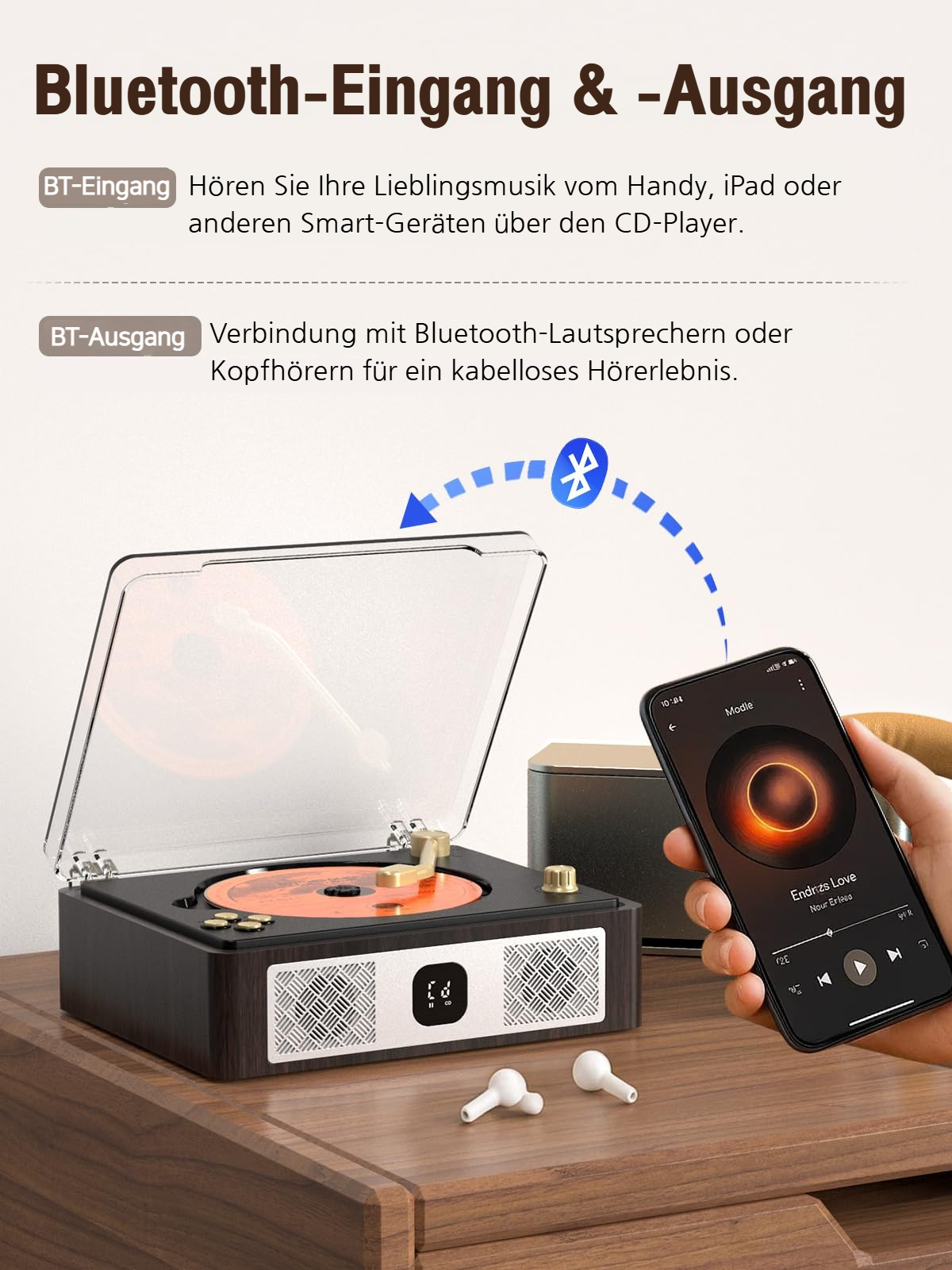 Schallplattenspieler mit aufklappbarem Deckel, Smartphone mit Musik und Kopfhörern.