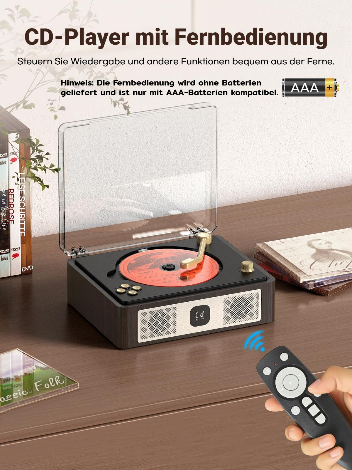 Ein Plattenspieler mit CD-Player und Fernbedienung auf einem Holzmöbel.