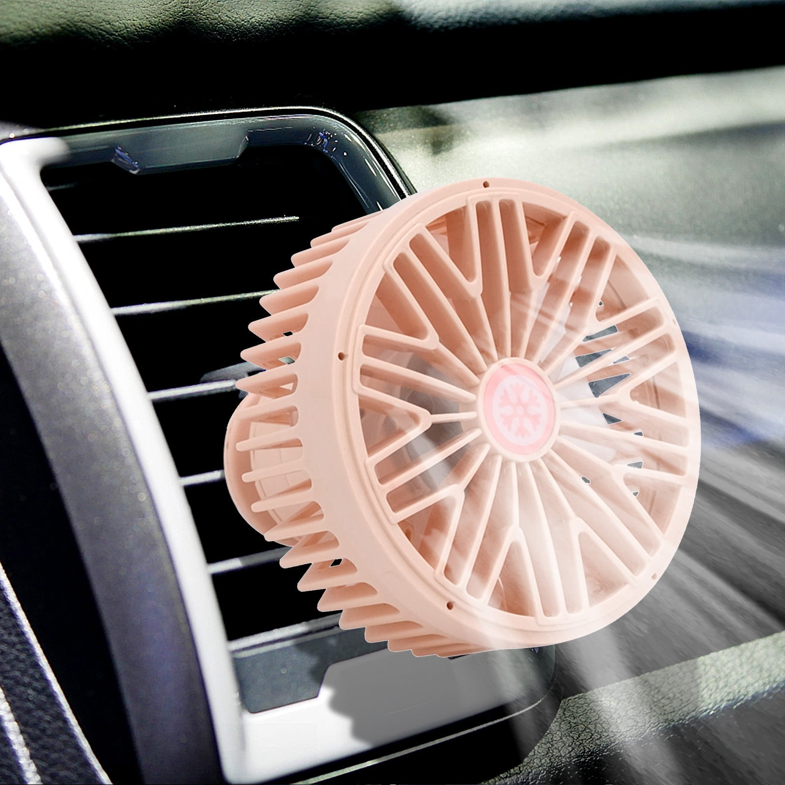 Ein rosafarbener Lüfterclip auf einem Auto-Lüftungsgitter mit sichtbarem Luftstrom.