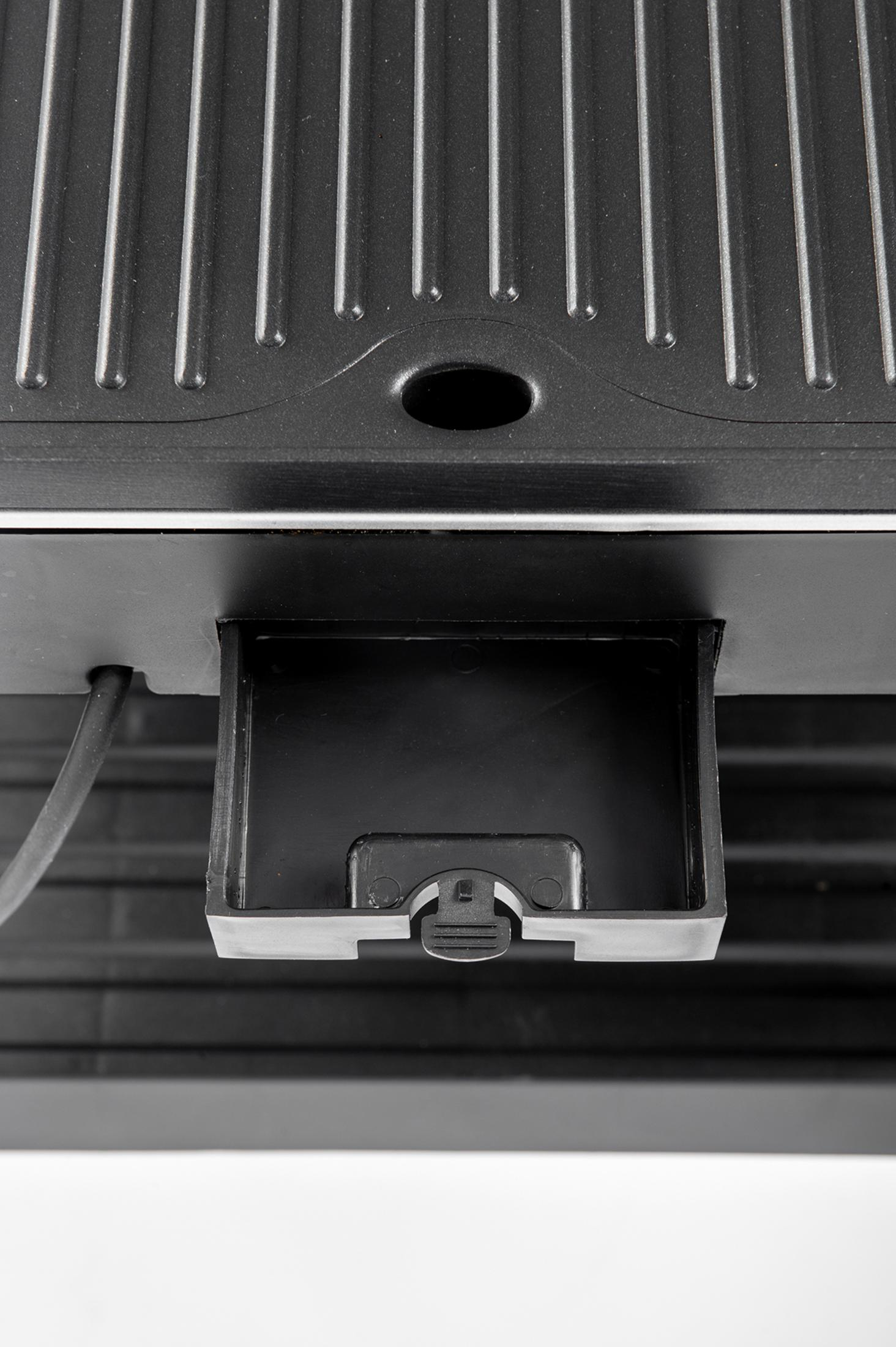 Primo piano di una griglia nera con scanalature e un vassoio raccogligocce estraibile.
