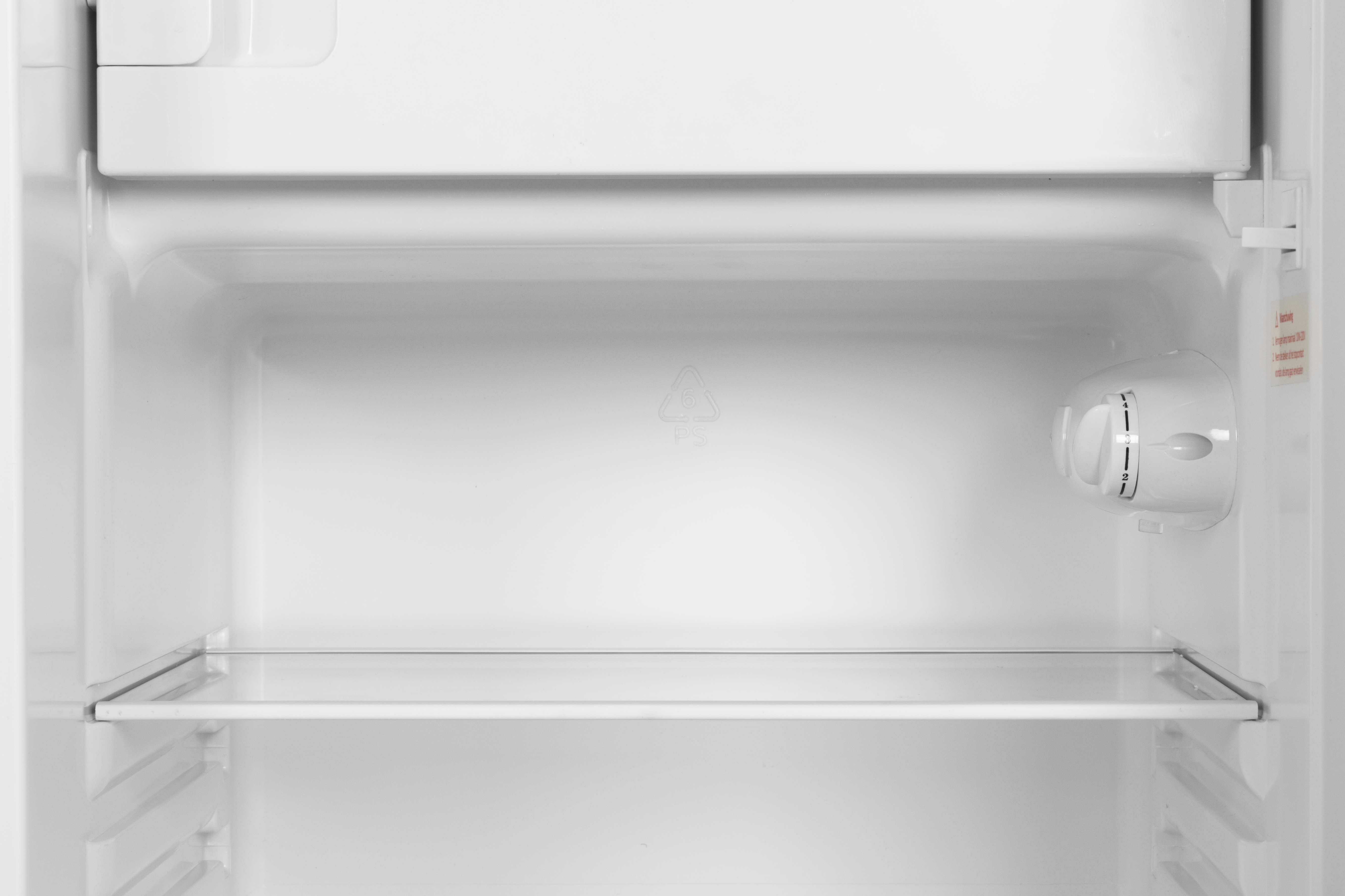 An empty, white refrigerator interior with one shelf and a temperature dial.
