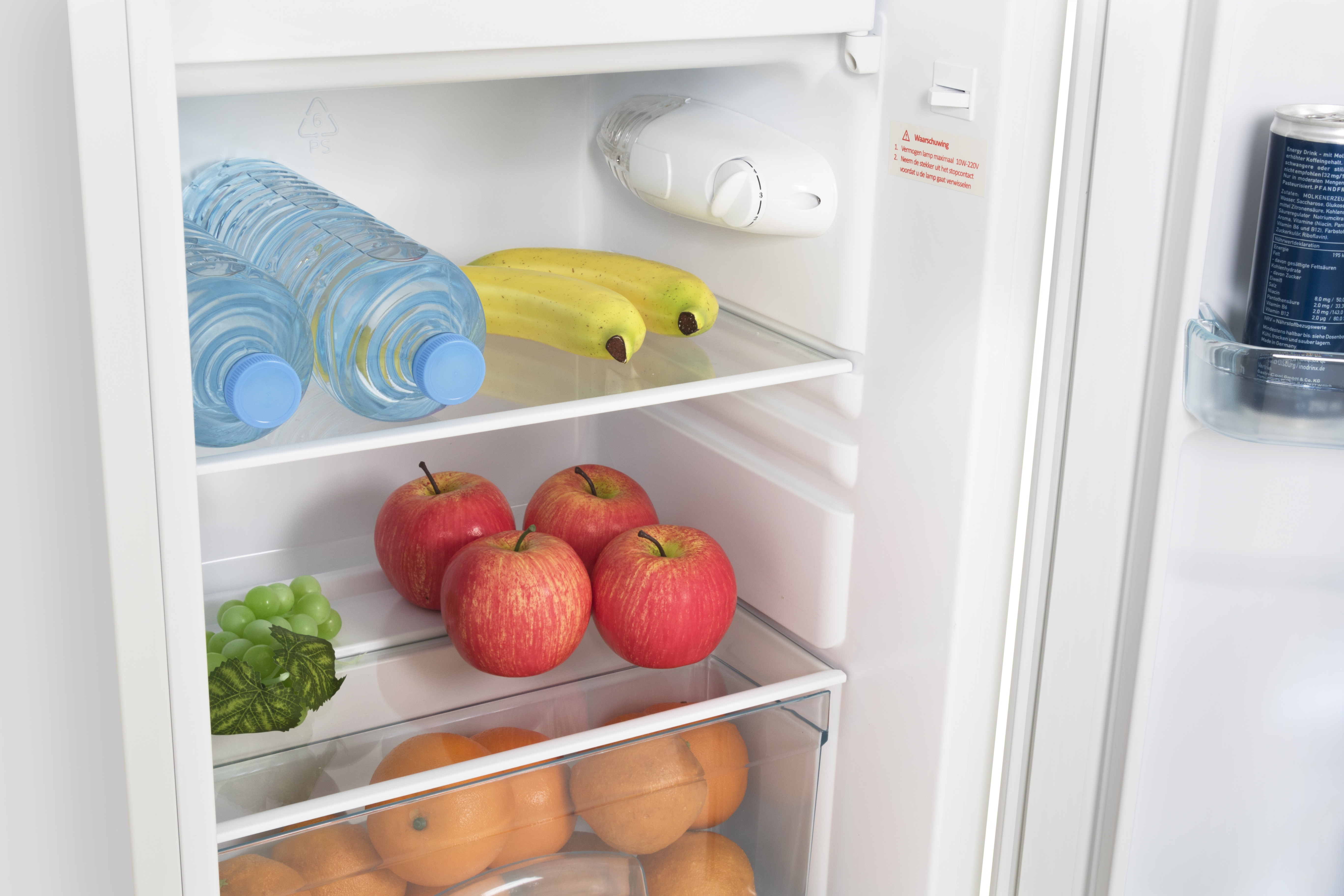 Refrigerator interior with water bottles, bananas, apples, grapes, and oranges.
