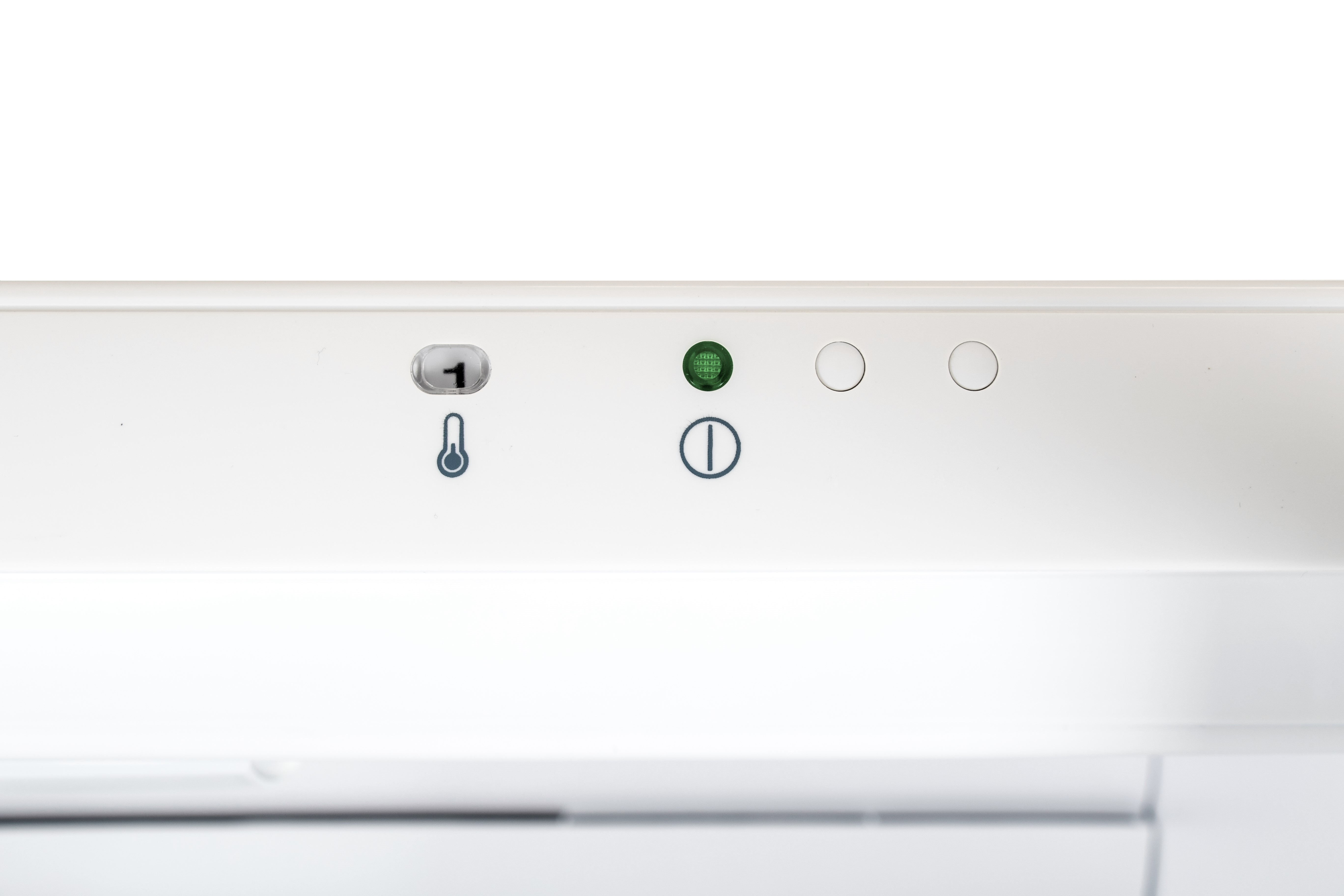 A white control panel with temperature and power icons.