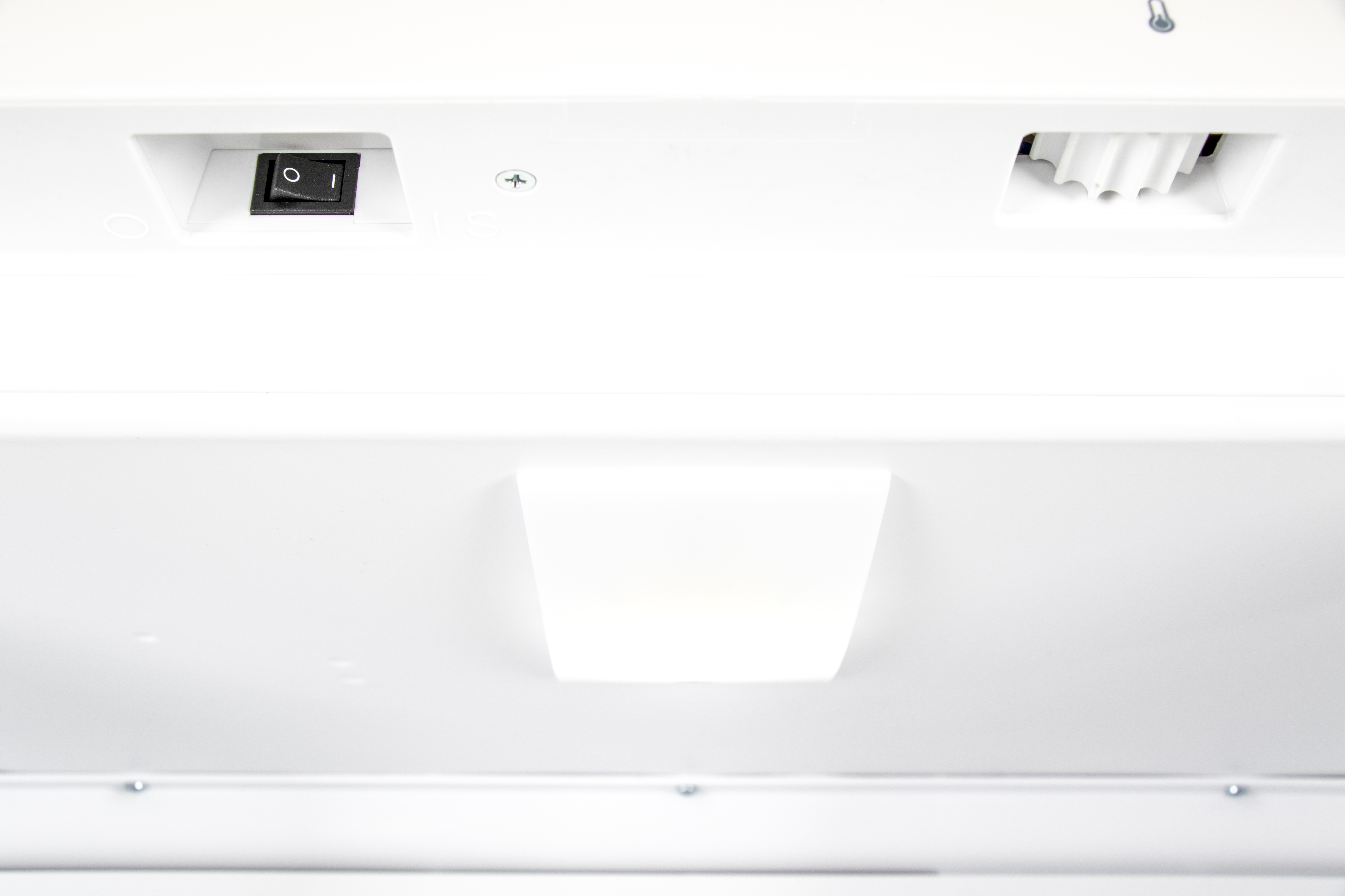 A black toggle switch with "0" and "I" markings on a white surface.