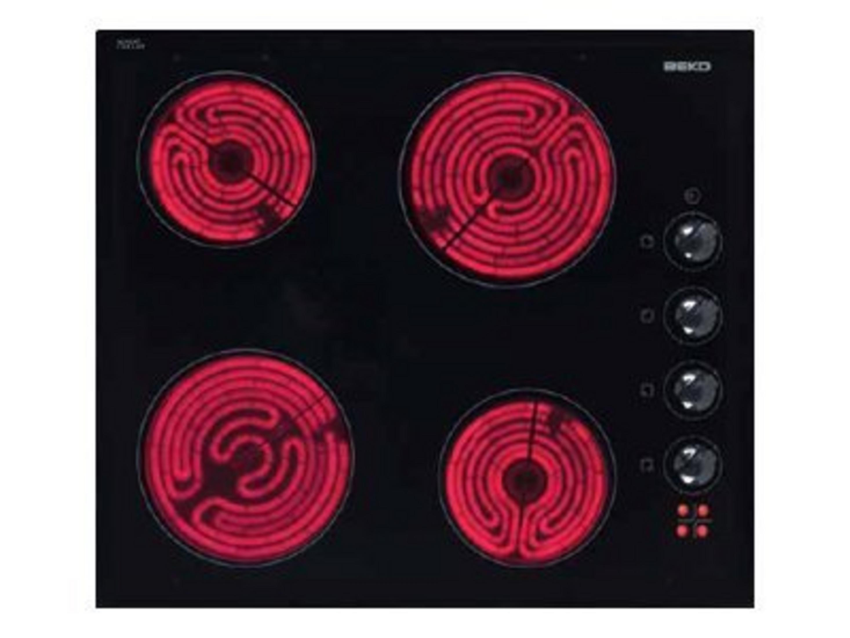 Un piano cottura nero con quattro resistenze rosse e quattro manopole.